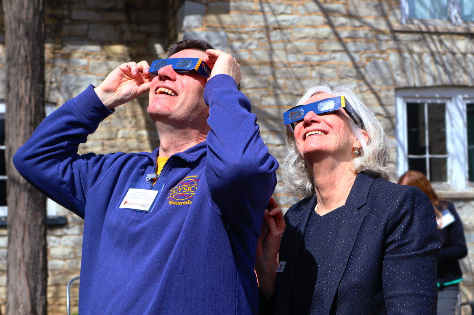 Dean Crow and Dr Robert Knobel looking up at the Eclipse through Eclipse glasses