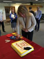 A faculty member getting a piece of cake