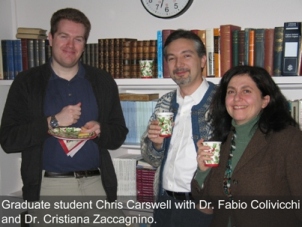 A student standing with two faculty members