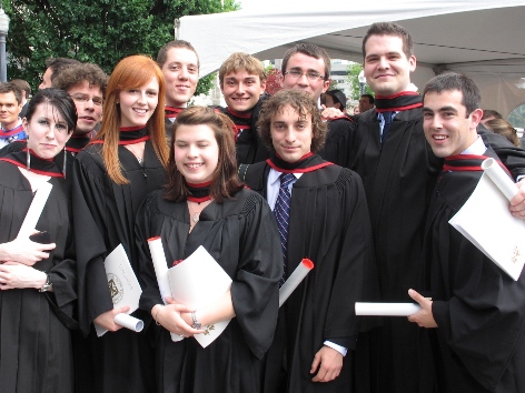 A group of graduates holding their degrees