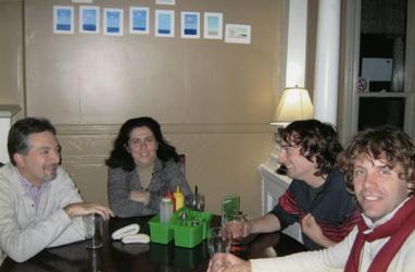 Four people seated at a table having a conversation