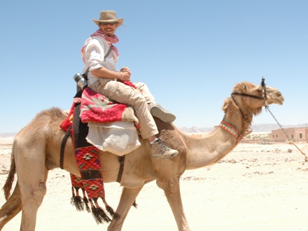 A person riding a camel