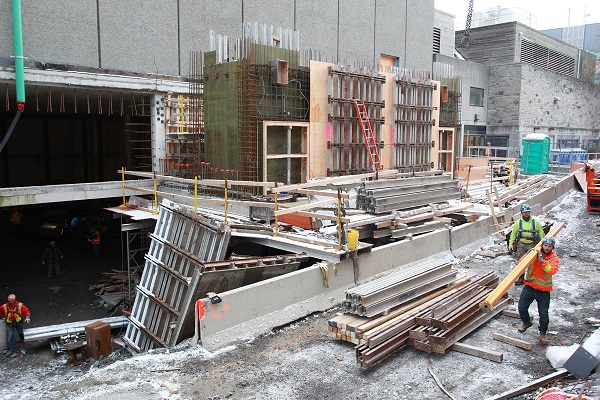 Crews are working to have the construction site fully enclosed by the holiday break. (Photo by Bernard Clark)