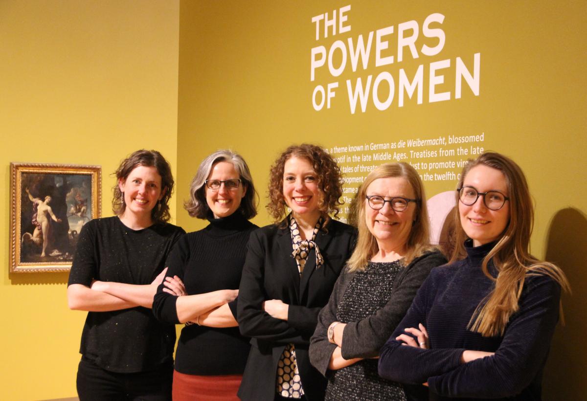 Five members of the Agnes Etherington Art Centre team, including Director Jan Allen (second from right), pose in the "Powers of Women" exhibit. (University Communications)