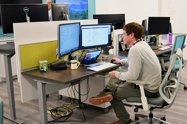[An ETL lab staff member uses an ergonomic desk] (Photo: PPS)