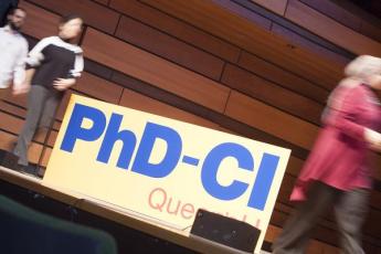 Students cross the stage at the PhD Community Initiative event at The Isabel