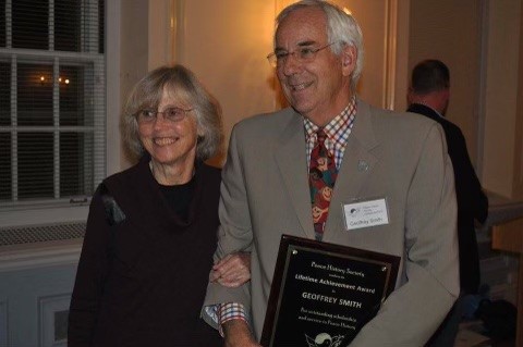 Image of Geoff smith accepting a Lifetime Achievement Award with his wife by his side