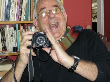 Image of Geoff Smith smiling with a camera