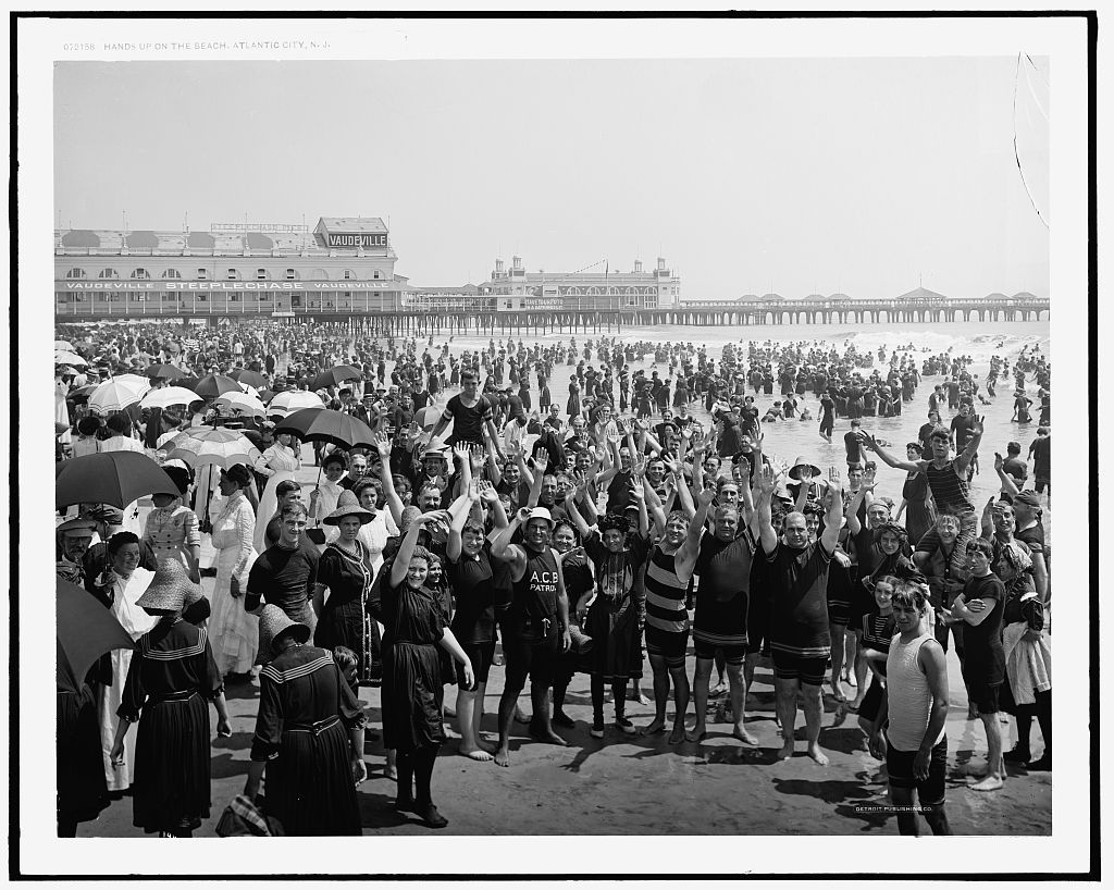 Image of a photo of a crowded beach on Coney Island around the turn of the century. 