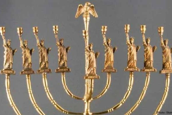 An image of a Menorah with the statue of liberty at the top of each candlestick