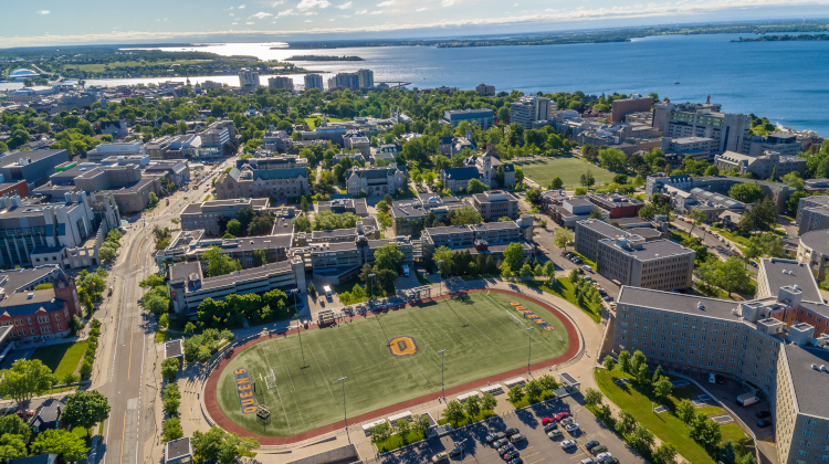 Aerial view of campus from west to east, with Tindall playing field in the foreground