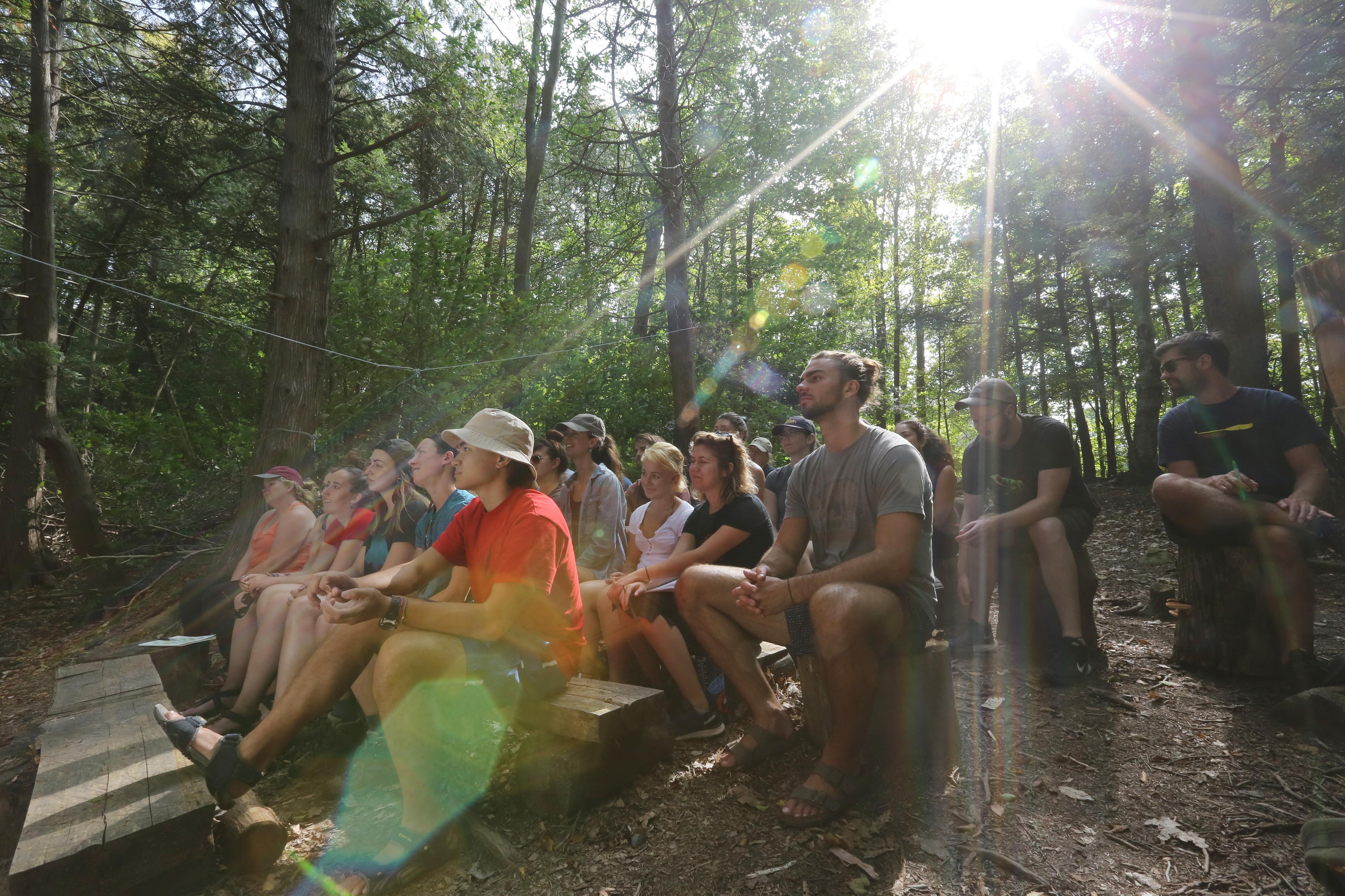 Photo by Greg Black - students sit in ourdoor classroom at Gould Lake