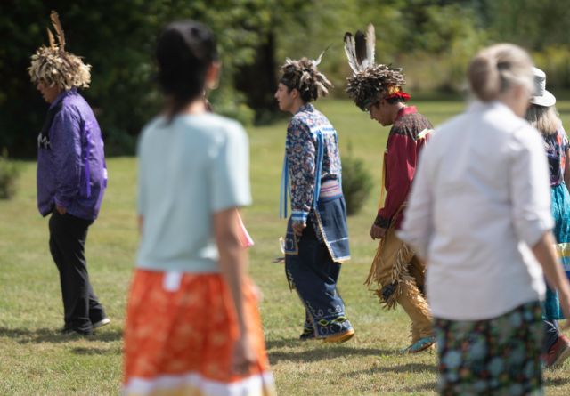 A group of people walk in a circle