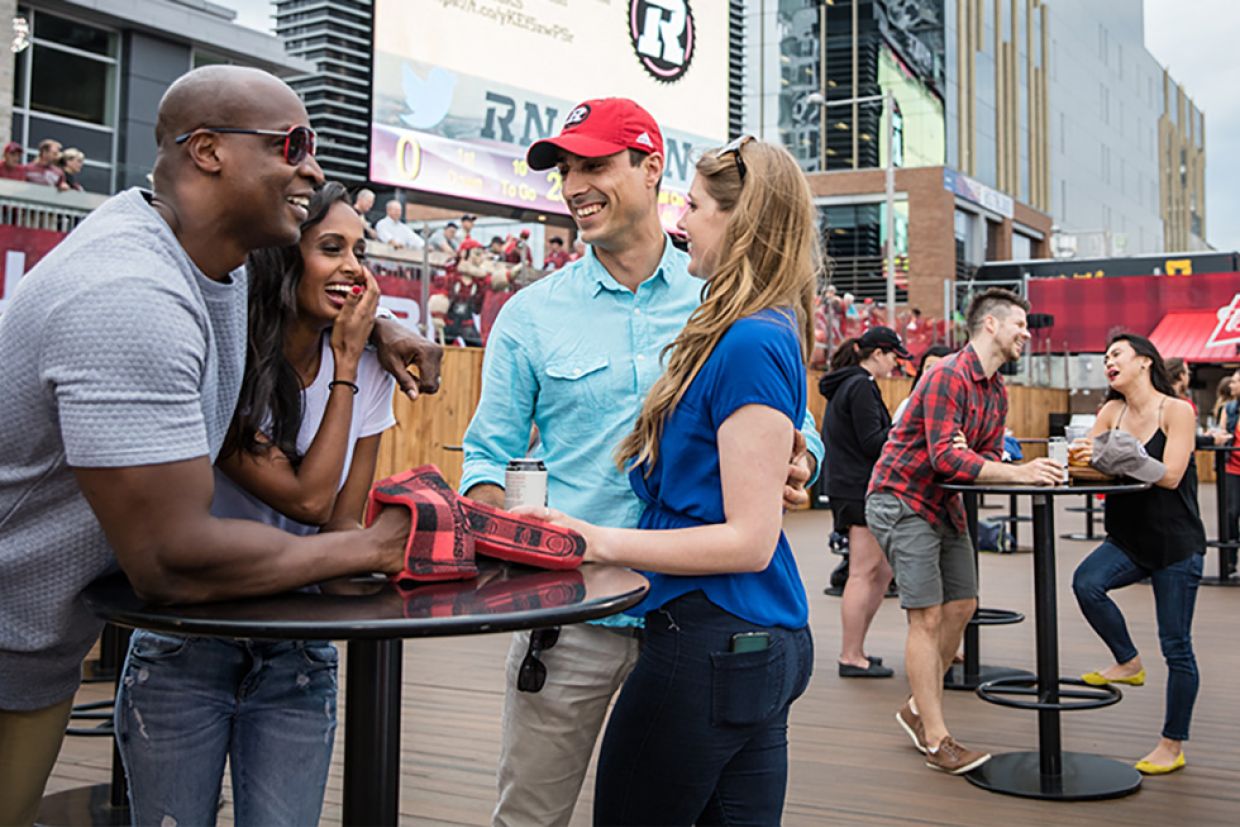 People gathered in the TD Place Lower Log Cabin