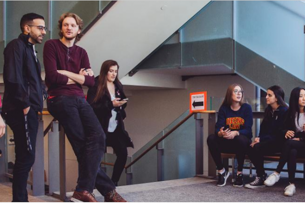 Law students discuss in the lobby of the law building.