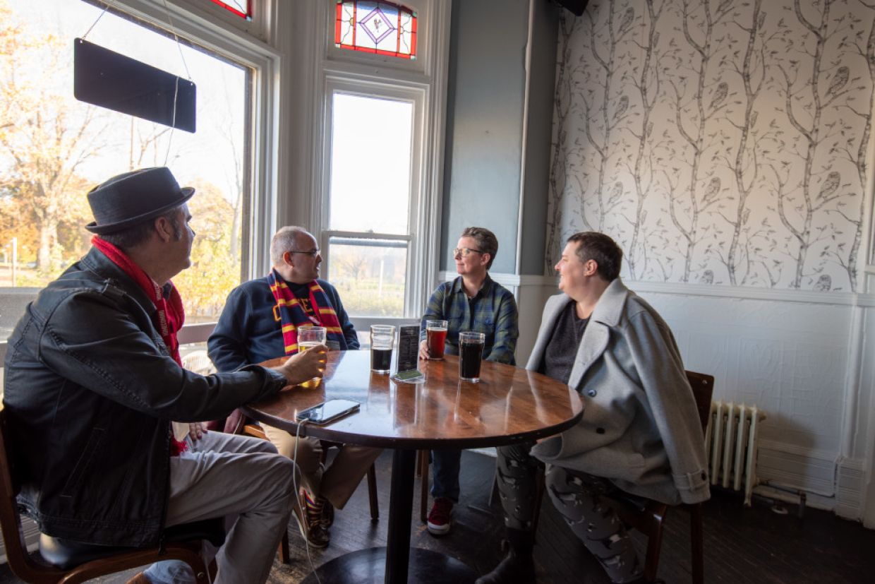 Alumni sit around a table in discussion