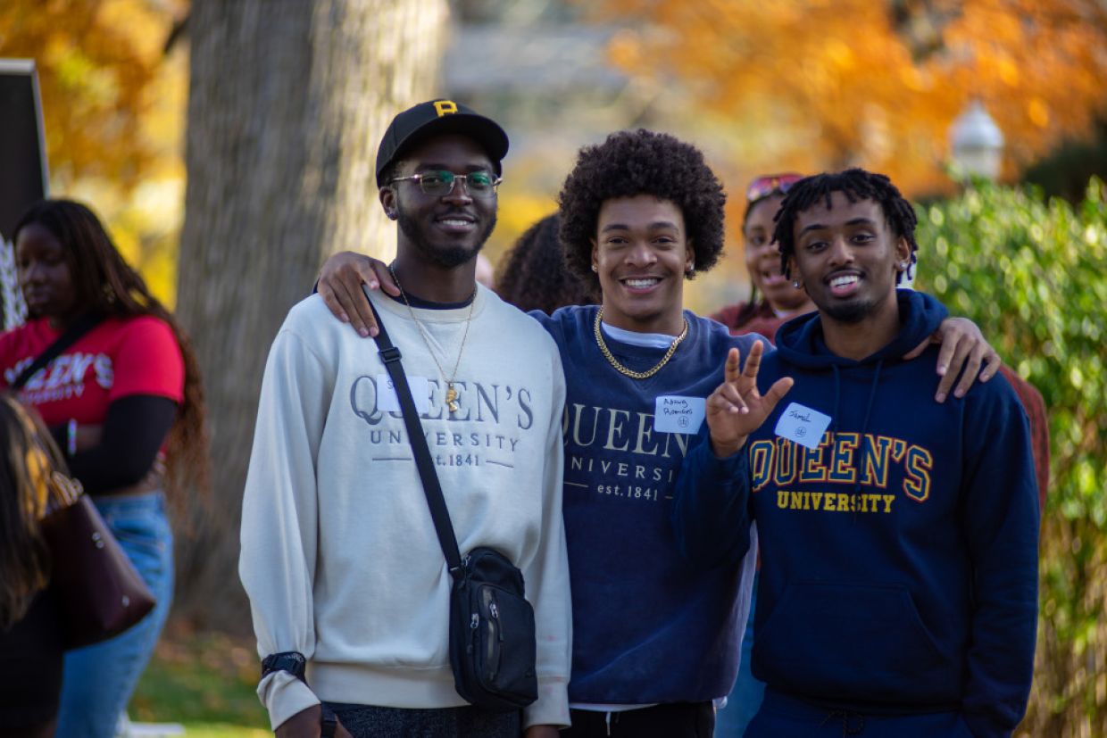 Members of the Black Alumni Chapter smile outside Summerhill building.
