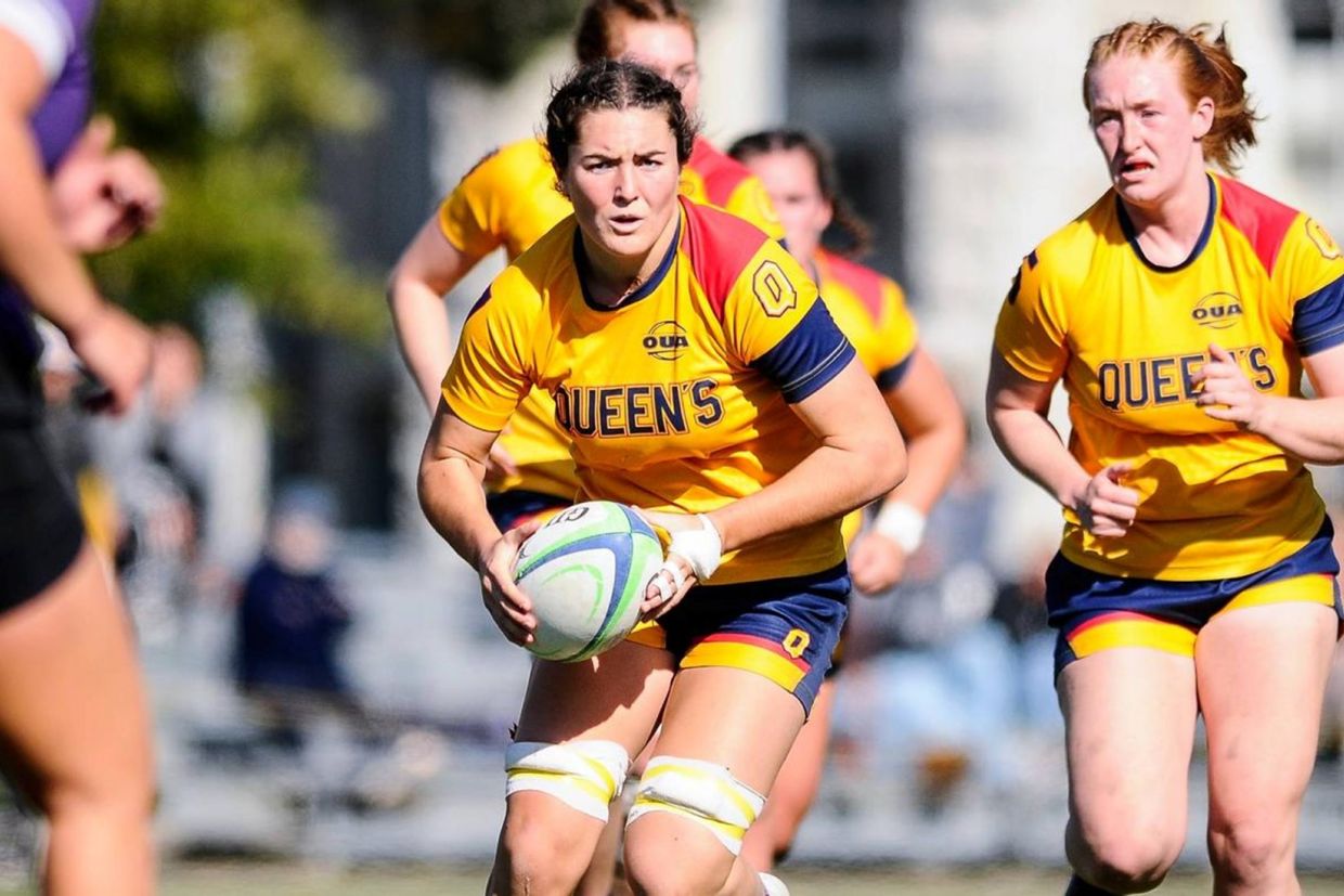 Women's Rugby player running with ball