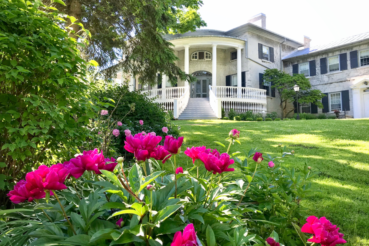 Flowers in bloom in the gardens in front of Summerhill-Benidickson House