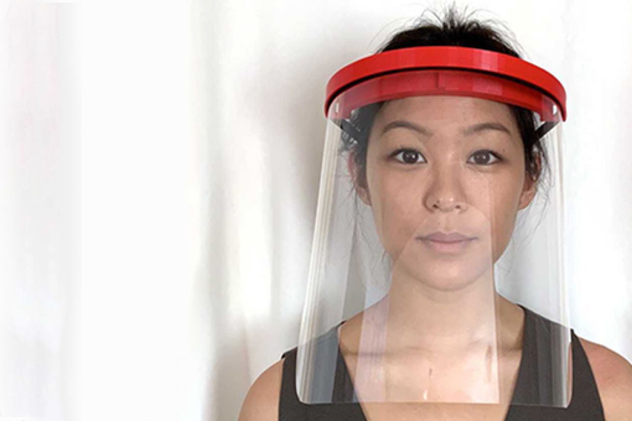 A photo of a woman wearing a face shield made using 3D printers
