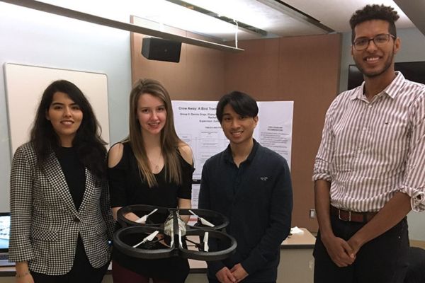 Undergraduate students holding a drone