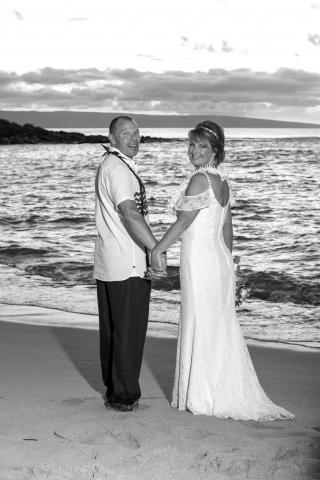 Sheri and her new husband, Robert, standing on the beach holding hands.