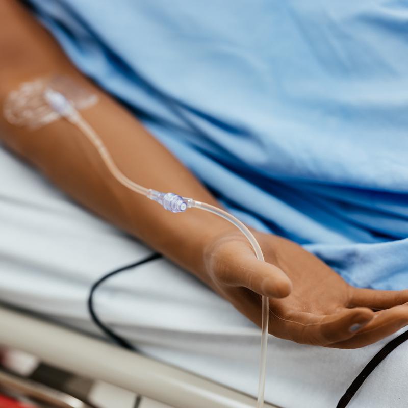 Close-up of the SimMan 3G Plus arm showing an IV attached to the inner elbow.