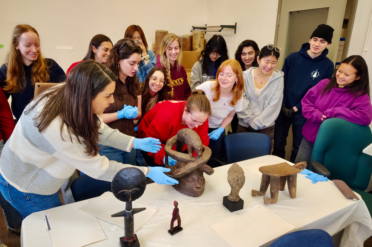 Students examining the Lang Collection of African art