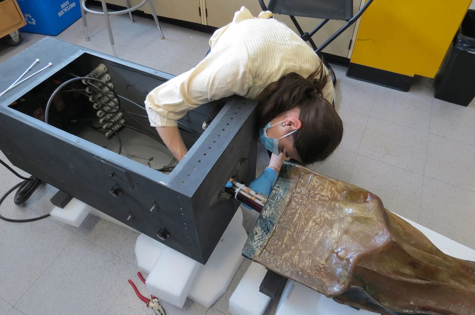 Antonia Mappin-Kasirer working on the restoration of the sculpture by Jean-Paul Mousseau.