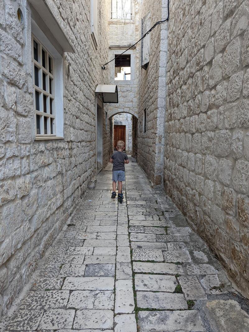 A boy on a scooter in Trogir, Croatia, 2022.