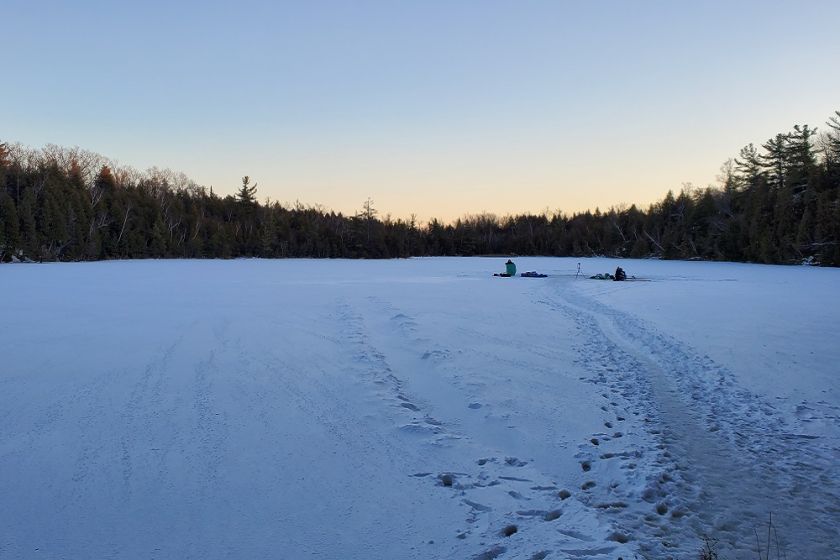 Crawford Lake in the Winter, frozen over with snow covering it. 