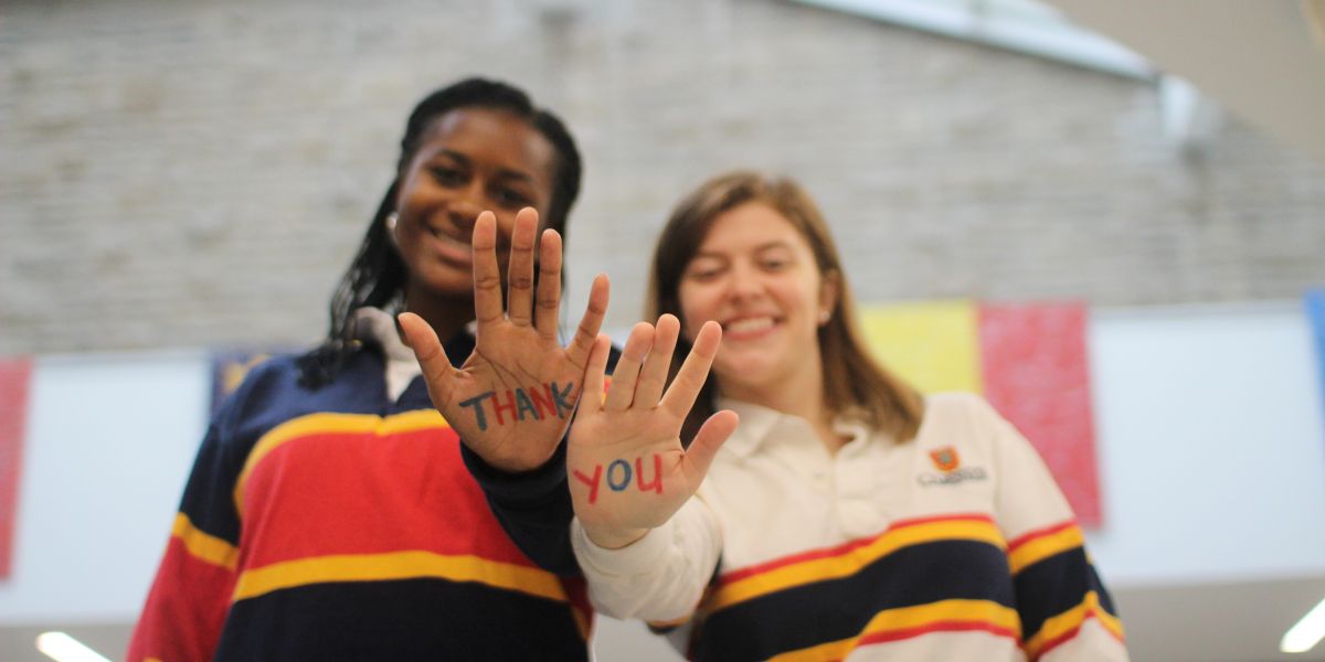 Students supported by the Dean of Arts Trust Fund with "thank You' Written on their hands