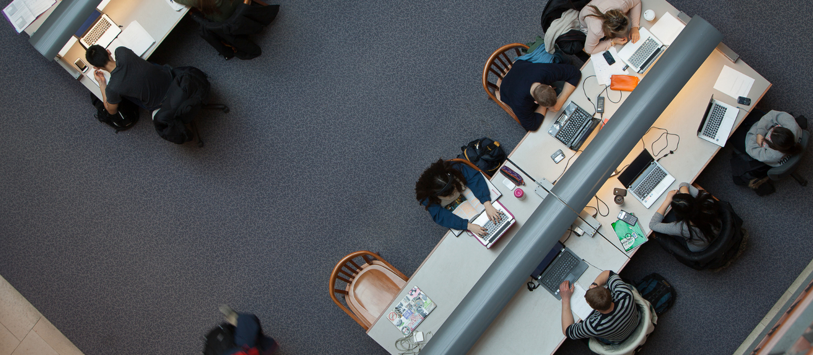 Students sitting at a table studying in the library/