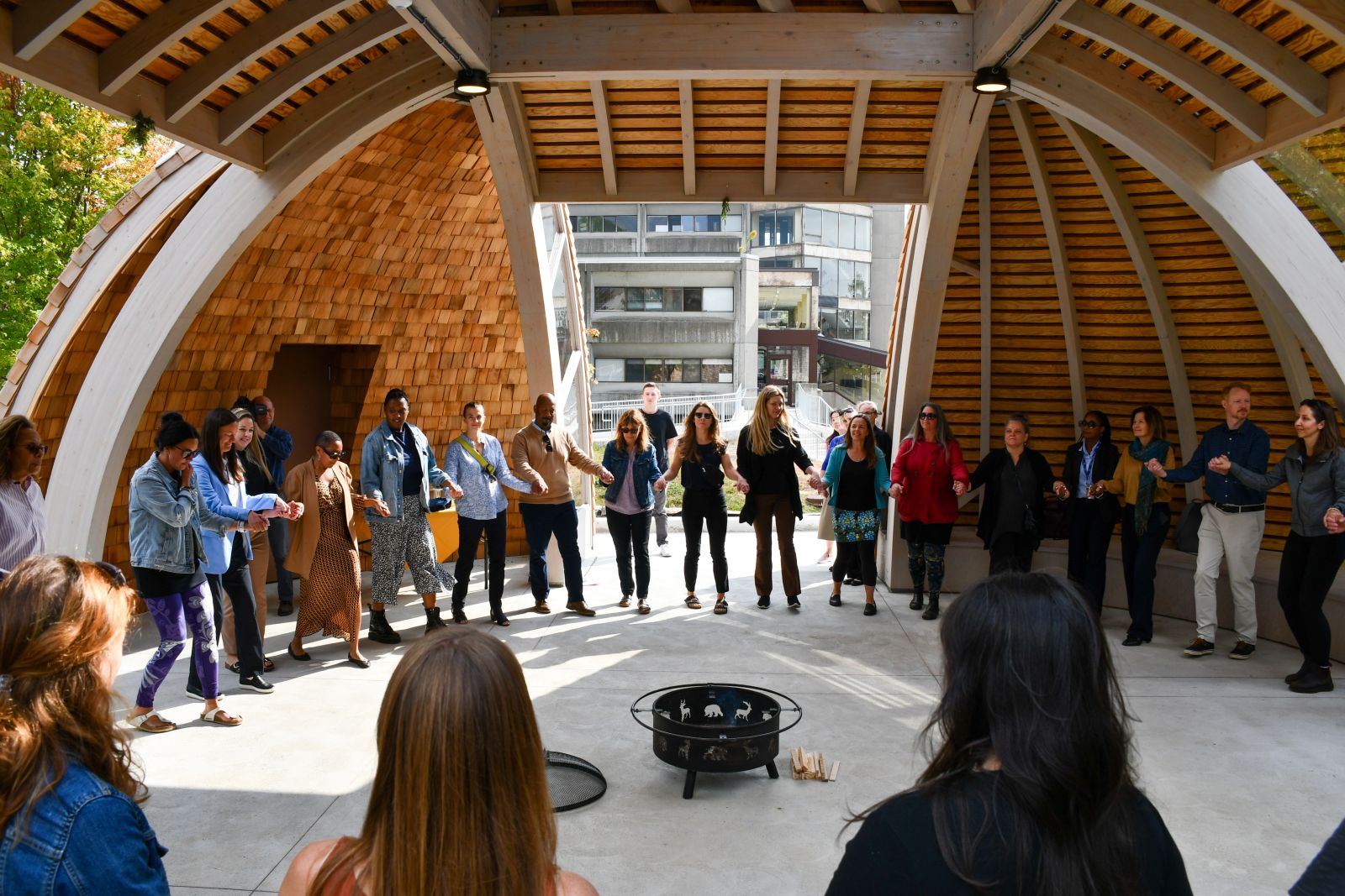 A group of people performing a traditional dance inside the new Indigenous space at Queen's University.