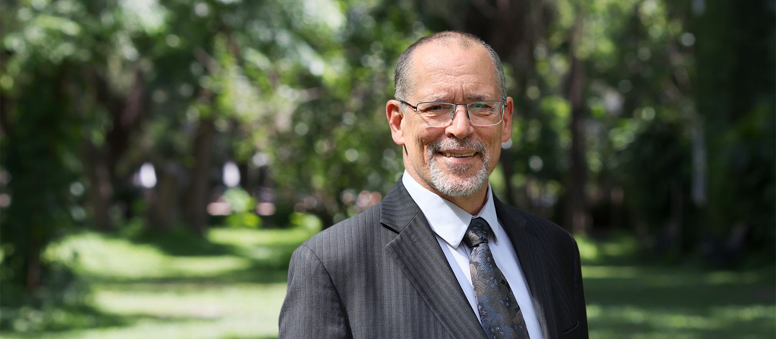 Dr. Bob Lemieux standing in front of trees.