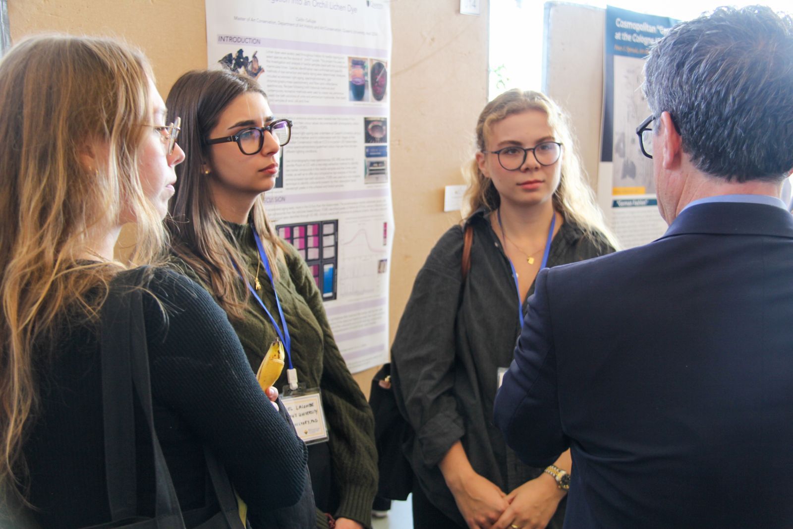 Dr. Gauvin Bailey speaks with attendees during the poster session.