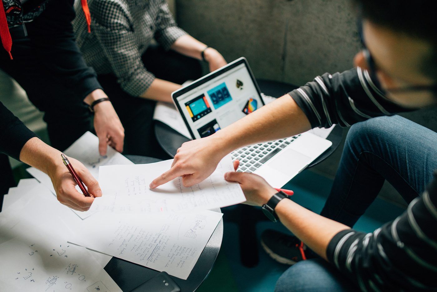 A group of students discussing something on a piece of paper