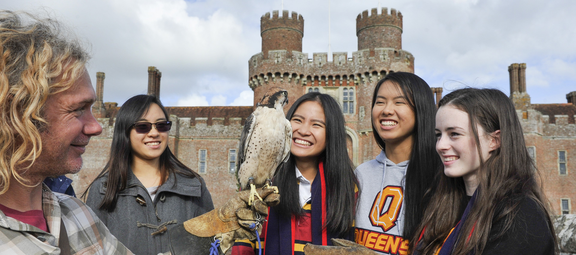 Students holding a bird of prey