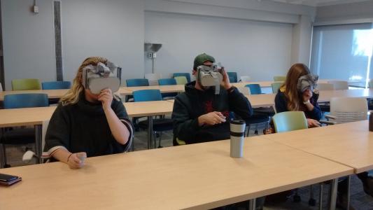 Three students wearing VR headsets