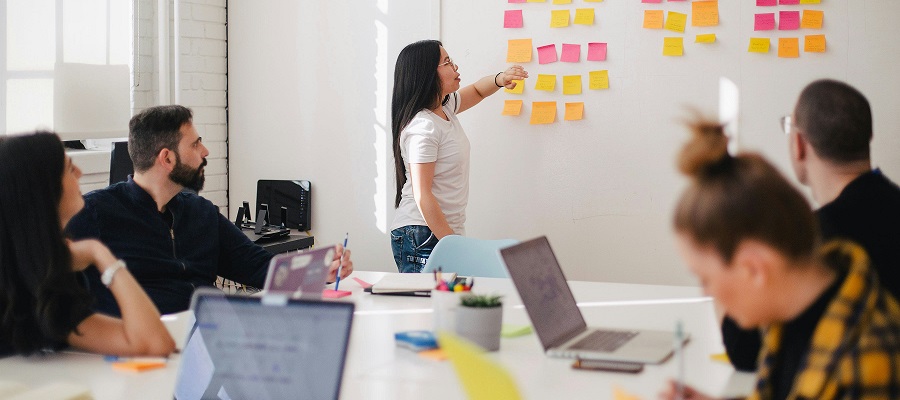 group looking t a wall with post-its