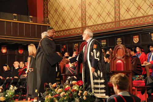 MIR grad walking across stage at ceremony