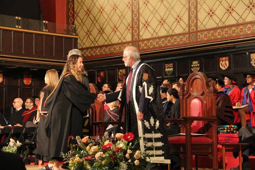 MIR grad walking across stage at ceremony