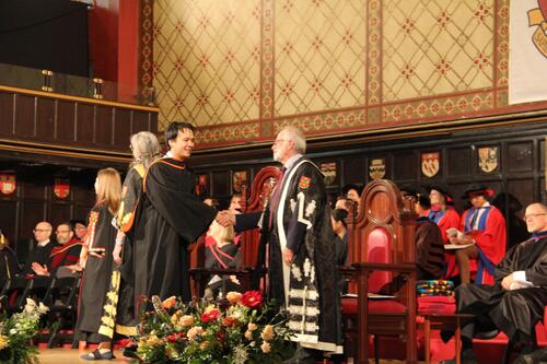 MIR grad walking across stage at ceremony