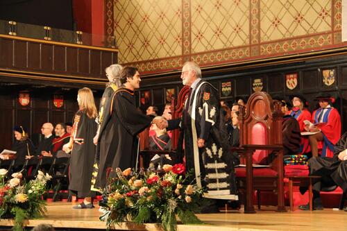 MIR grad walking across stage at ceremony