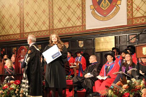 MIR grad walking across stage at ceremony