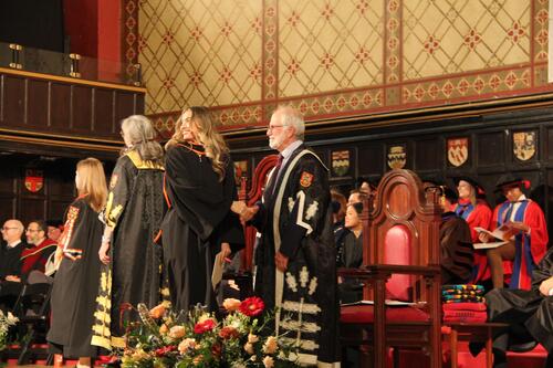 MIR grad walking across stage at ceremony