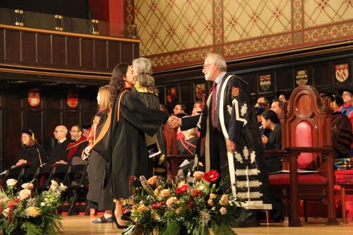 MIR grad walking across stage at ceremony