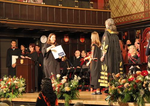 PMIR grad walking across stage at ceremony