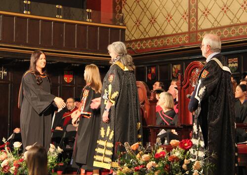 PMIR grad walking across stage at ceremony