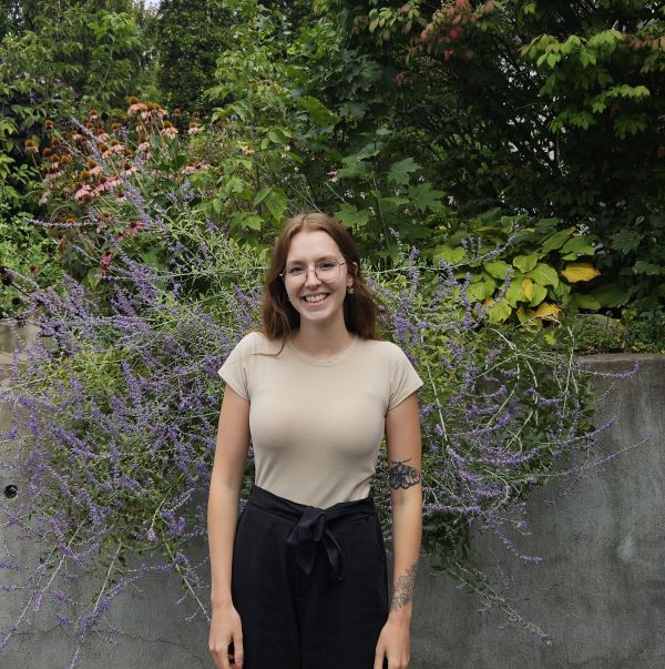 photo of student standing in front of lavender bush